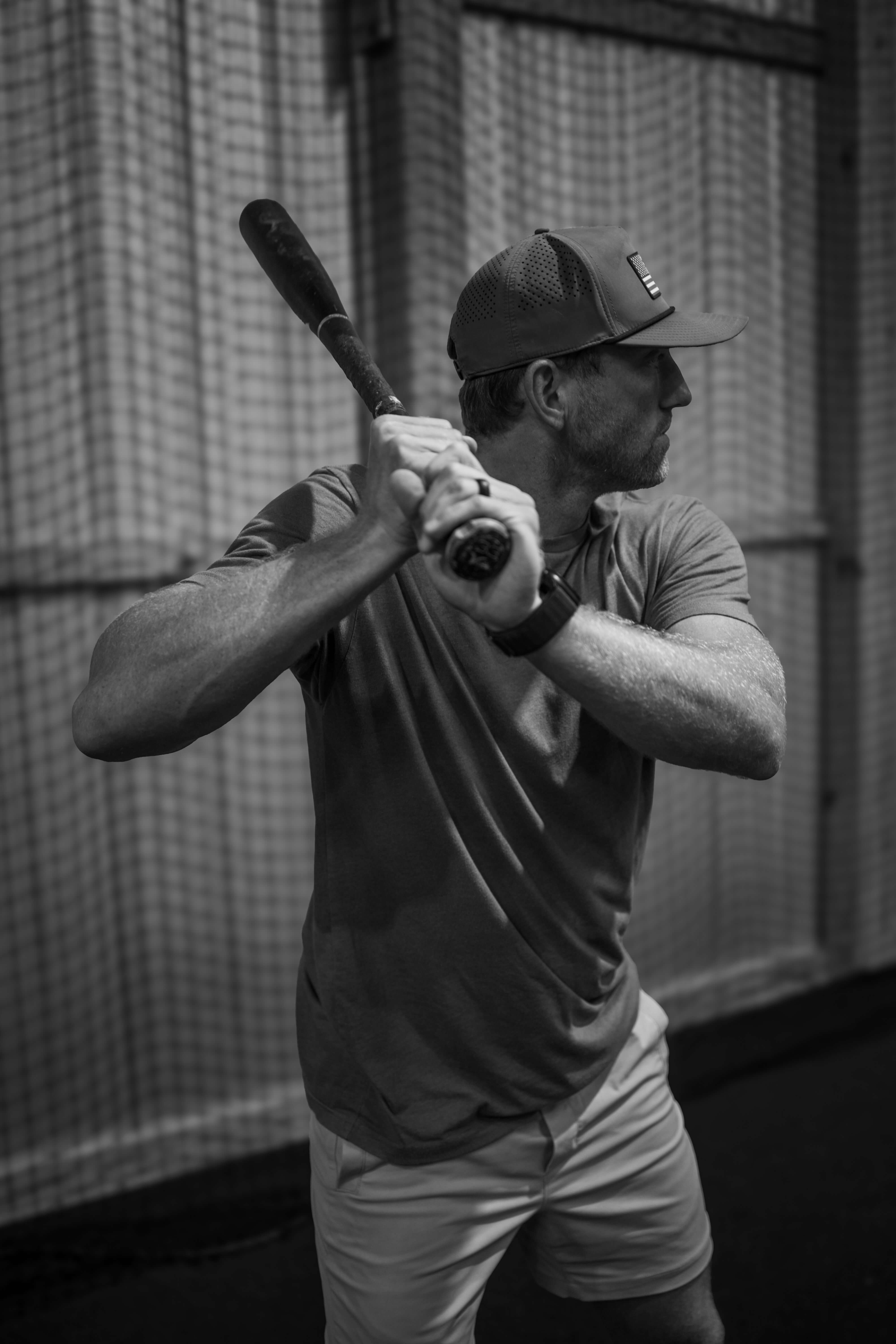 A baseball player standing on a freshly cut outfield at Kingdom Built Performance